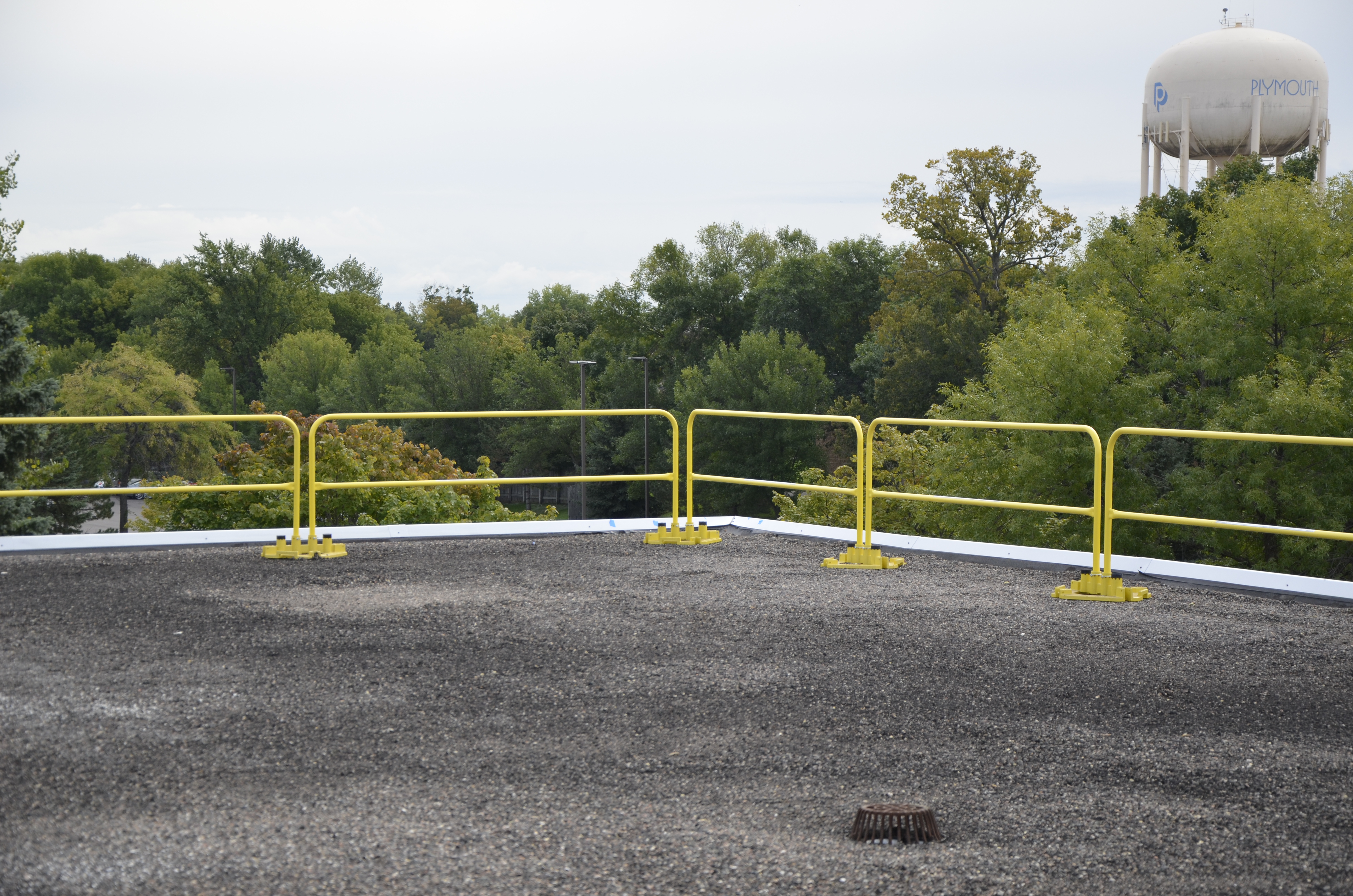 Pre-formed guard rail with metal bases